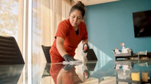 Janitor cleaning office conference table