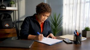 Facility manager reviewing cleaning checklist at desk
