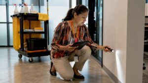 Facility manager inspecting cleaned office hallway
