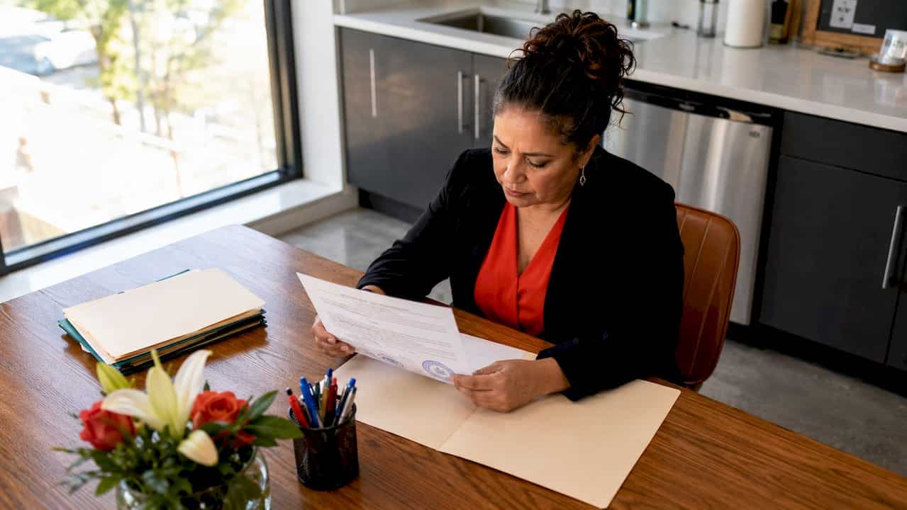 Office manager reviewing bond certificate