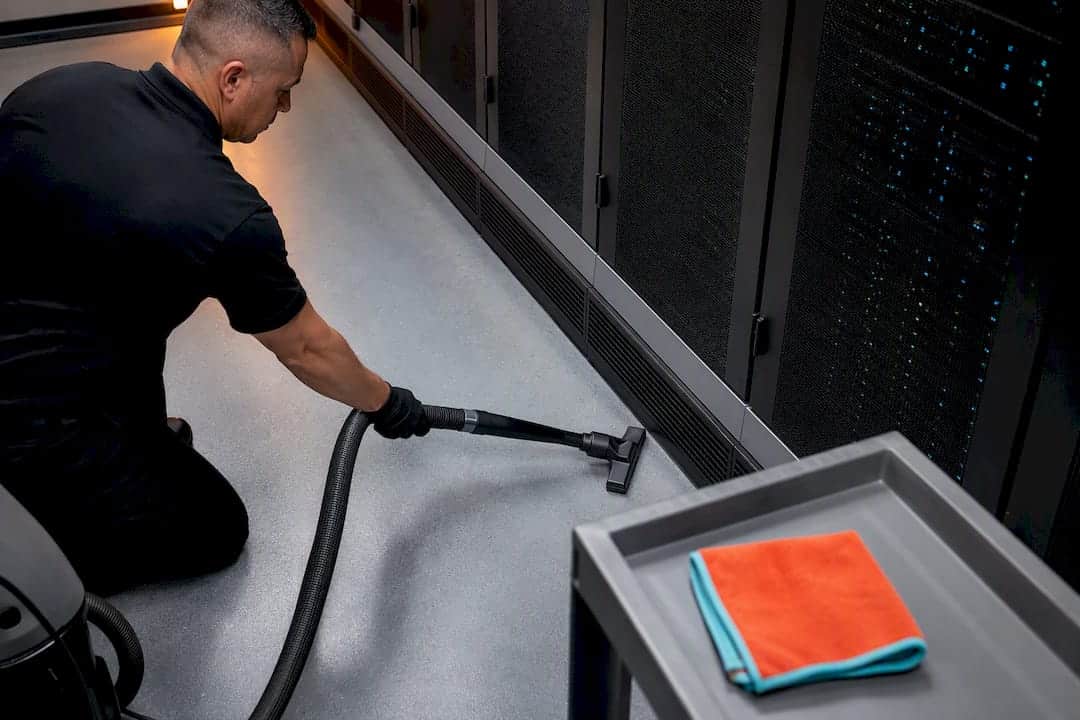Grounded HEPA vacuum beside server equipment