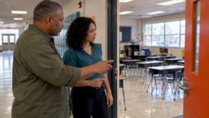School staff reviewing classroom cleaning scope